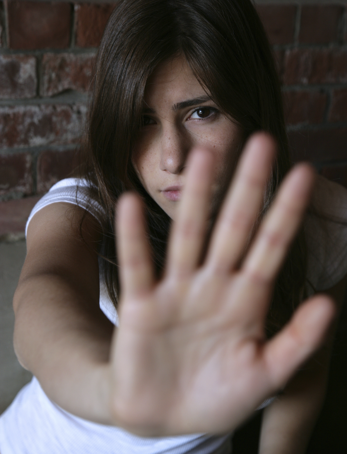 girl guarding herself with hand up