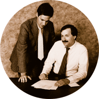 Circular black and white photo of two men in business attire.