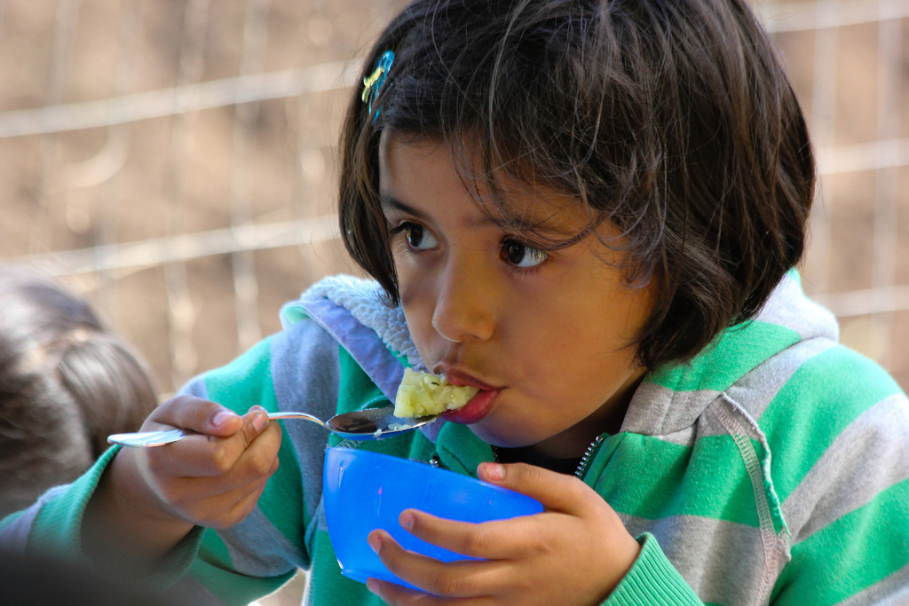 A Concord International School 3rd grader tastes food made from fresh ingredients at Lettuce Link's Giving Garden at Marra Farm.
