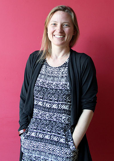 Kira Zylstra smiles for a photo at Solid Ground headquarters, where she began her career in Seattle.