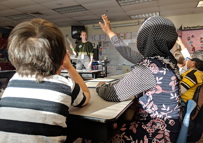 Chef Annika gathers information about how to use a knife safely from the students in after-school cooking club. (Photo by Emiline Chipman)