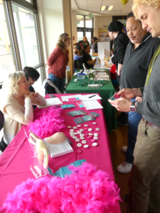 Health fair attendees stop at CanCan's table, a breast and ovarian cancer awareness organization.