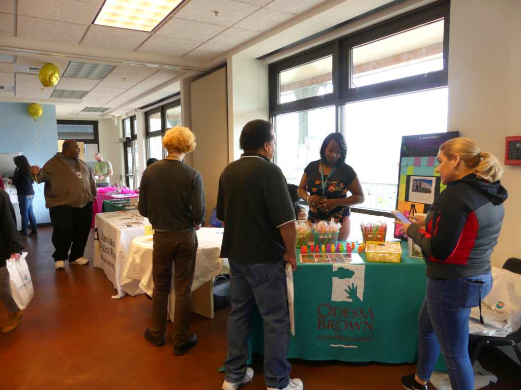 Health fair attendees visit the Odessa Brown Children's Clinic table.