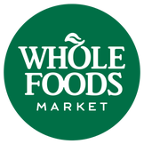 WHOLE FOODS MARKET logo in a kale green circle with white lettering