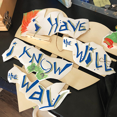 Mixed media art piece with blue and gray lettering on an ivory broken-heart backing. Text reads: i Have the Will/ i Know the Way
