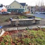 An opposite view of one farm work table before construction, with the garden in the background.