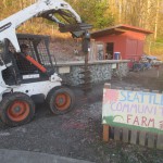 Construction crews get ready to dig the holes for the shelter support posts.