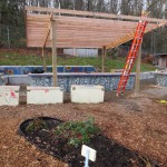 The surface lumber is positioned and attached, completing the canopy base structure.