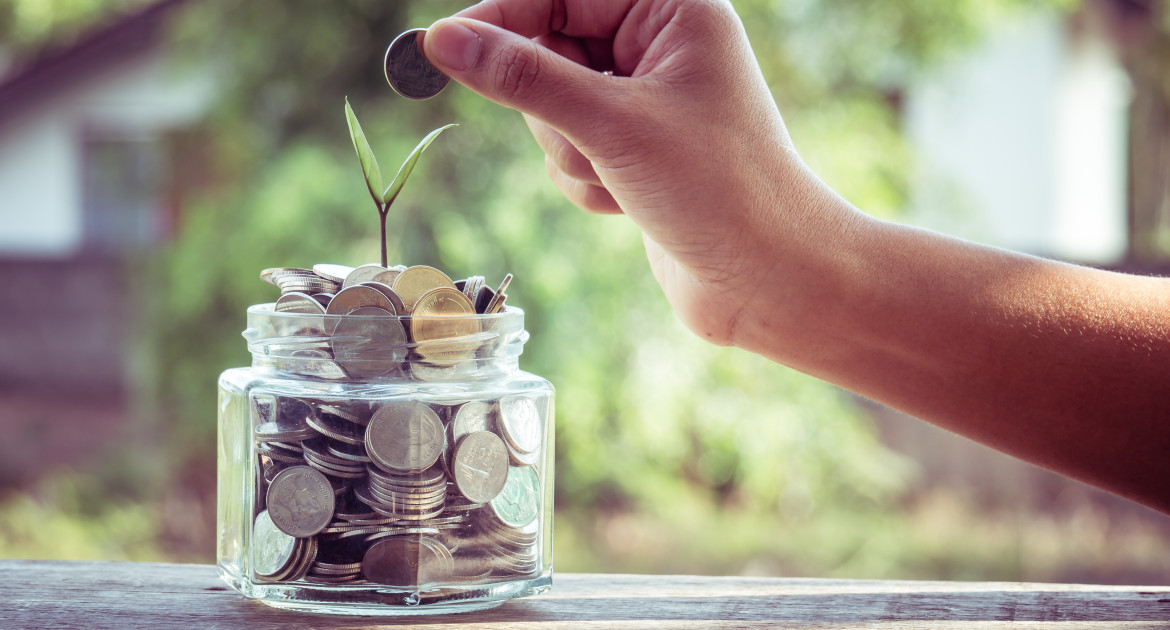 hand putting money coins with filter effect retro vintage style