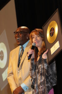 Emcee Nancy Guppy presents Wanz with a golden album award (photo by John Bolivar)