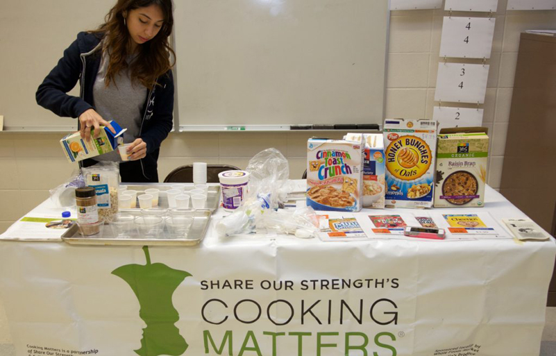 AmeriCorps member Michelle Huete prepares for a pop-up Cooking Matters at the Store tour.
