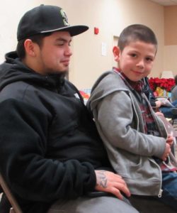 Anthony sits on his Uncle Jeremy's lap, MLK Lobby Day 2015 (photo by Liz Reed Hawk)