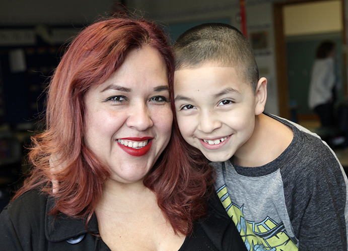 Maricela & Jonathan in his 2nd grade general ed classroom: "Every day I repeat with him, ‘I am smart, kind and handsome,’ and he likes that part, of course! He is getting more aware of his potential, because when he’s reading he says, ‘I know how to read! You want me to read a book for you?’” (photo by Bellen Drake)