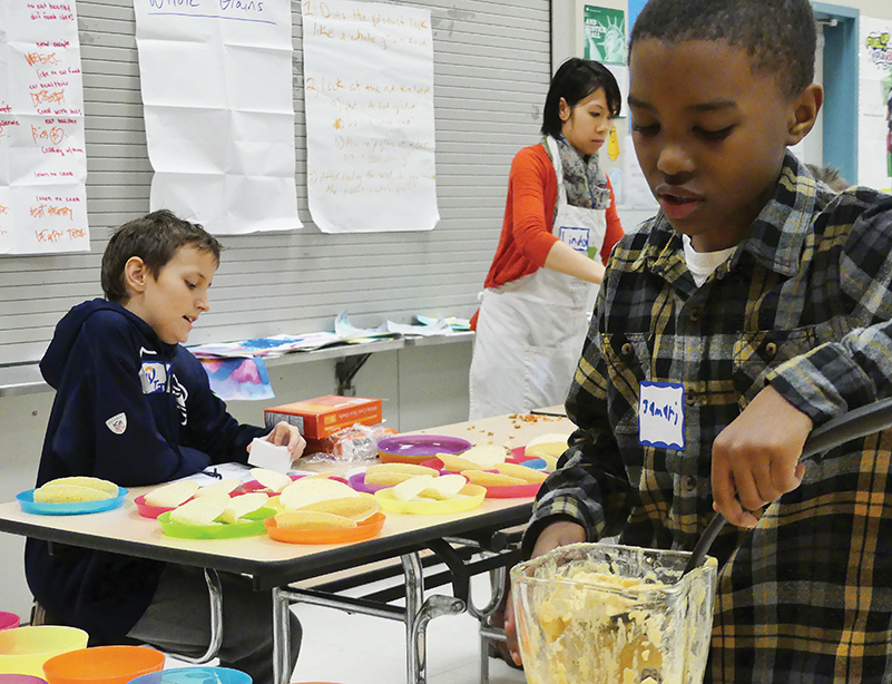 Jamari serves his carefully spiced hummus for his classmates (photos by Liz Reed Hawk).