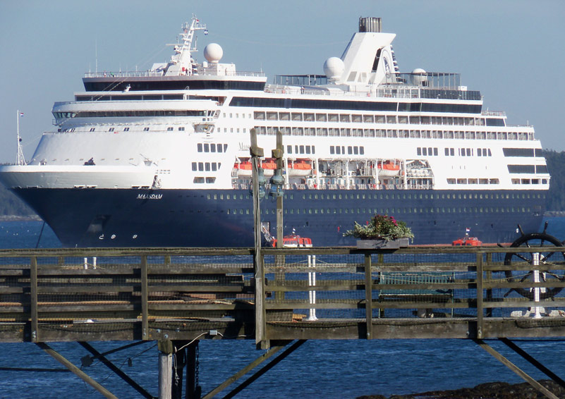 A large cruise ship on clear blue water