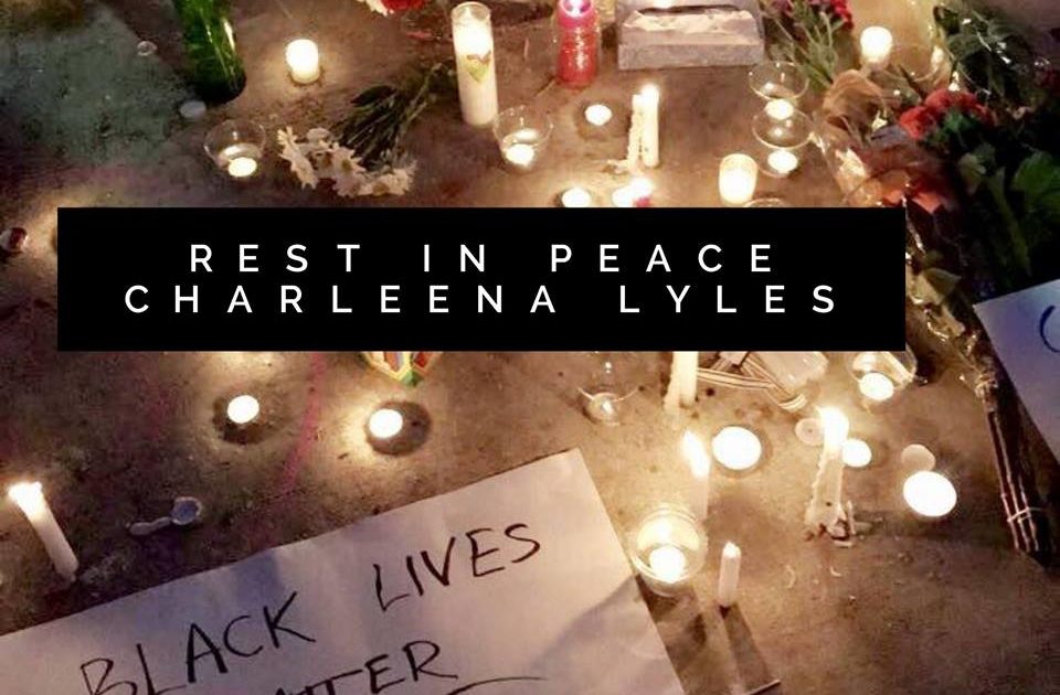 Flowers and candles creating a shrine to Charleena Lyles