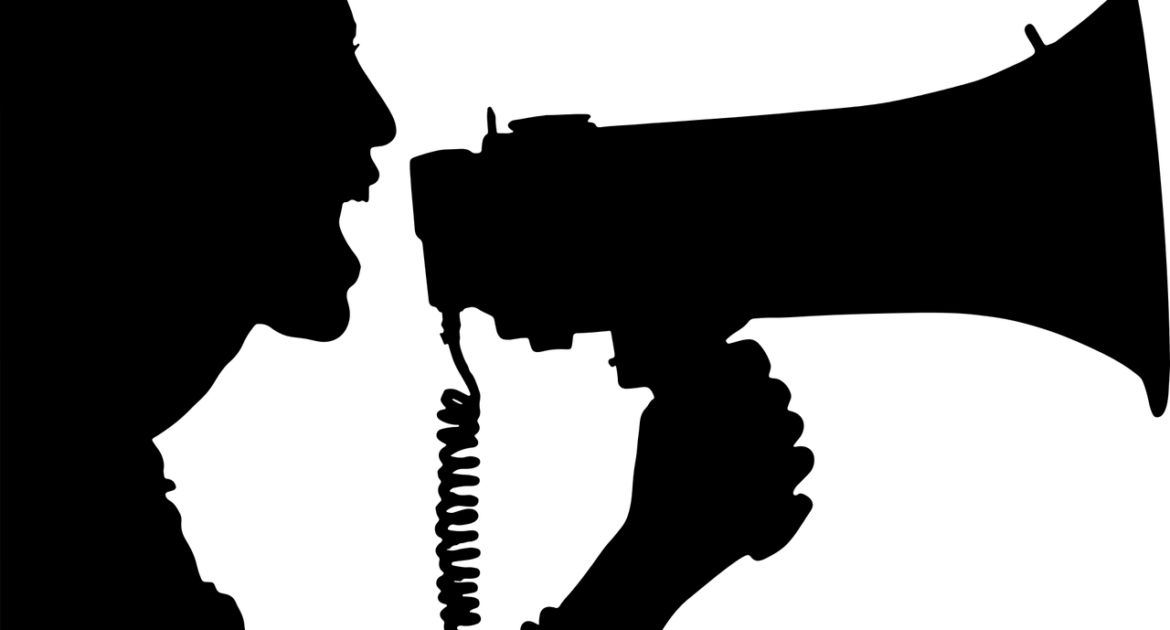 silhouette of woman speaking into a megaphone
