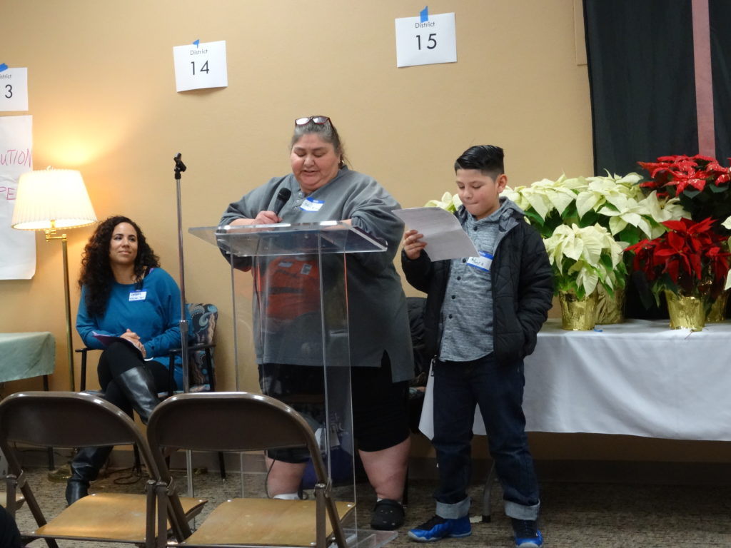 Vanessa Cobbs looks on as Poverty Action Board Chair, Juanita Maestas, & her grandson Anthony make the “ask” during Lobby Day.