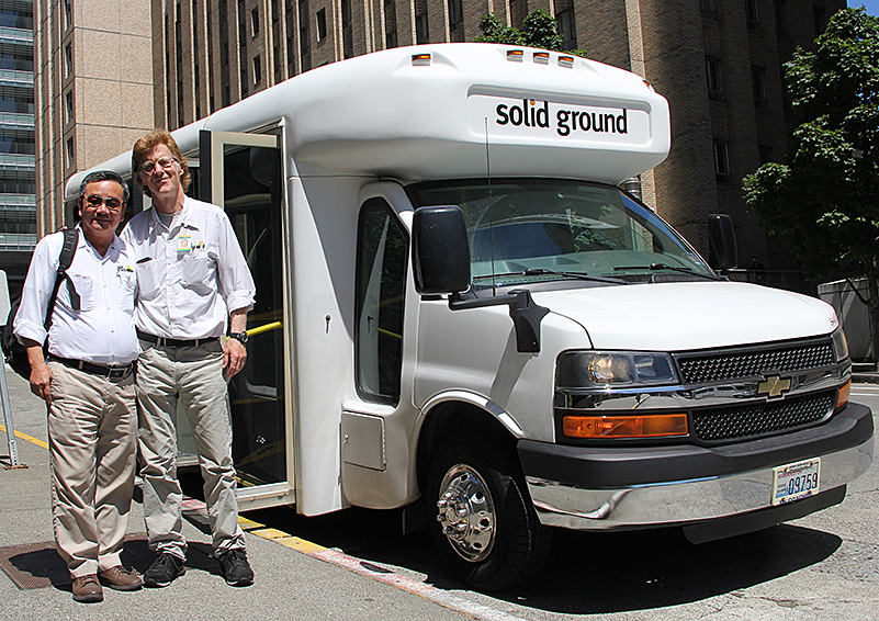 Downtown Circulator Bus Driver Joe McCrea (right) takes over the Circulator to give his fellow Driver, Phuong Nguyen (left), a lunch break (photo by Lara Breitkreutz).