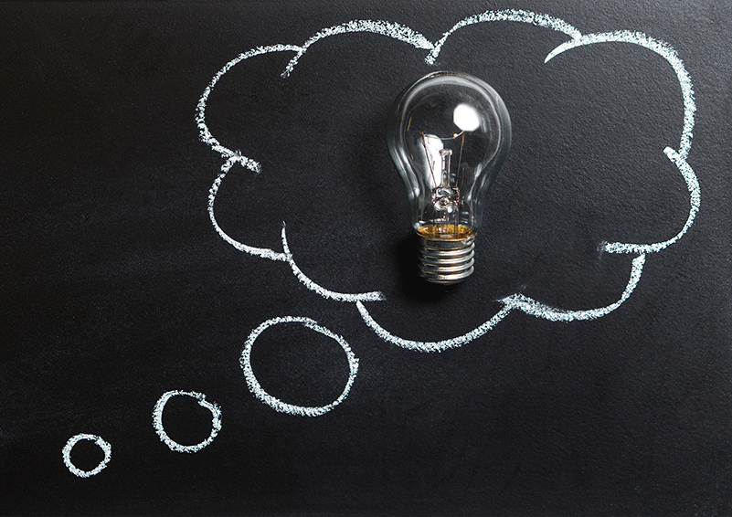 Chalkboard with a thought bubble surrounding a lightbulb