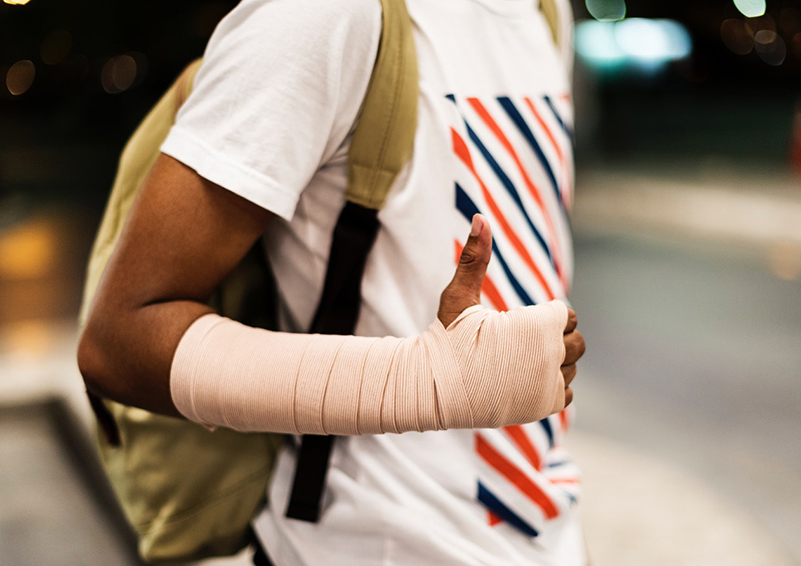 Young person with sprained wrist gives a thumbs up.