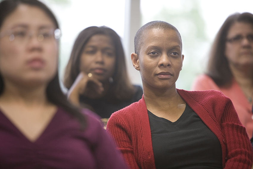 A group of women sitting and listening attentively