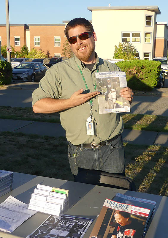 Magnuson Community Center's Doug Oaksford holds up some print materials.