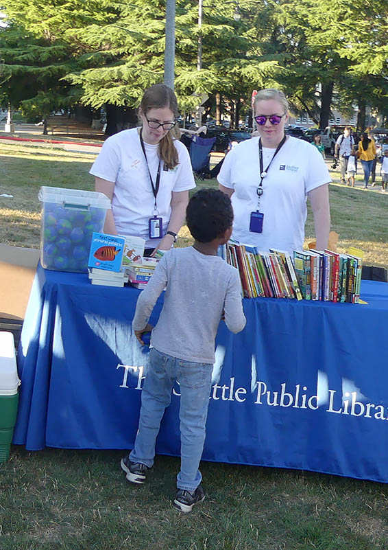 A mobile library customer chooses his book carefully.