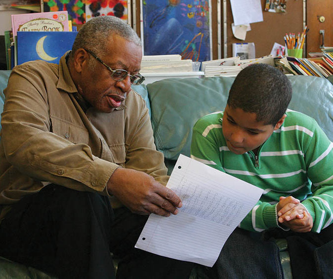 Older man tutors young boy