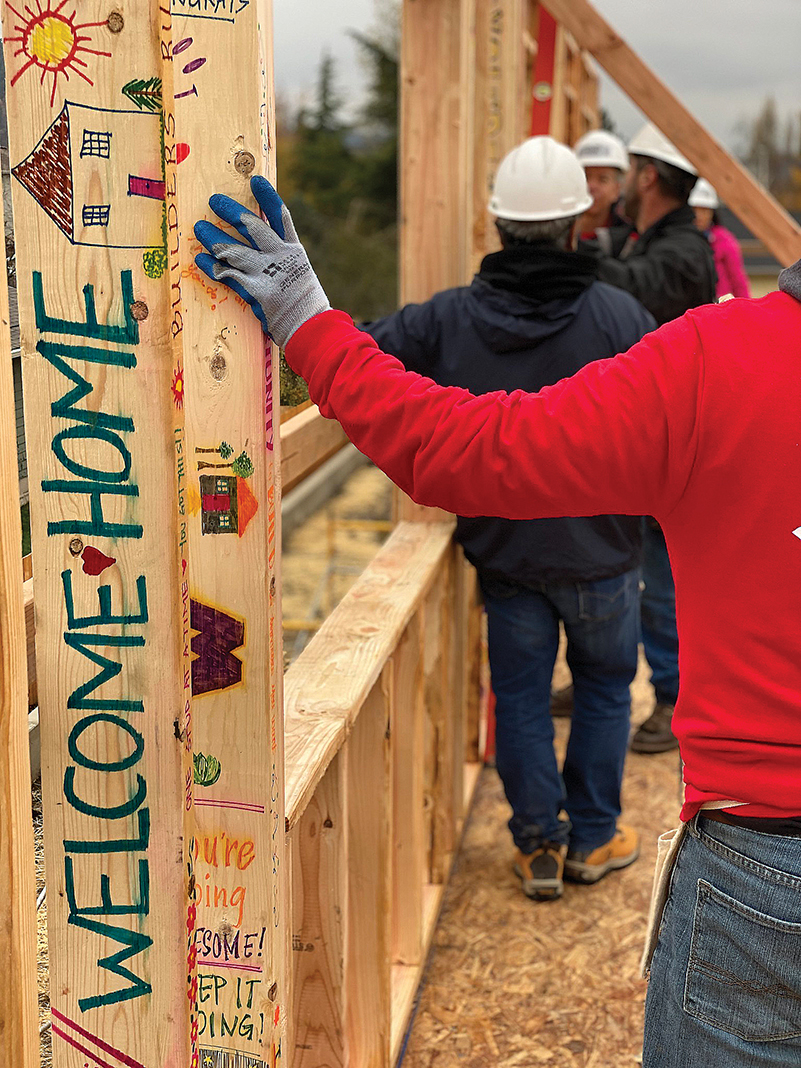 Habitat for Humanity volunteers wrote a "Welcome Home" message on a framing beam.