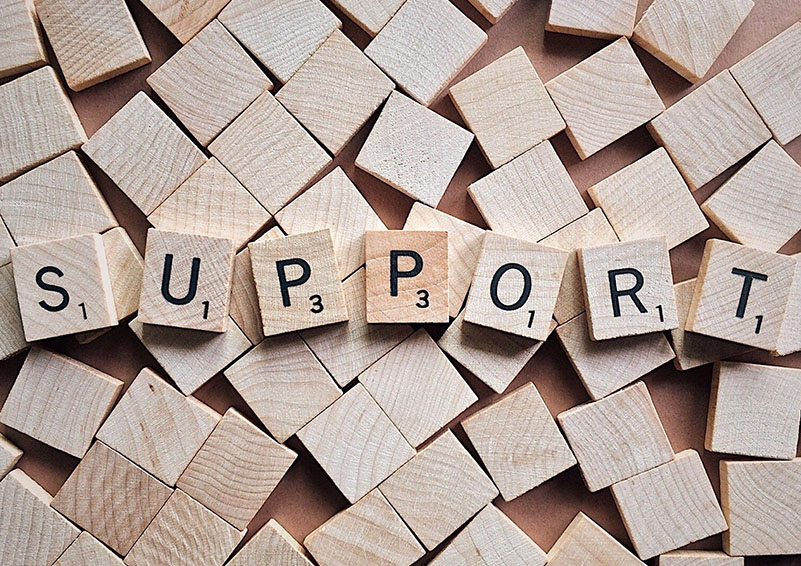 Scrabble tiles spelling "support"