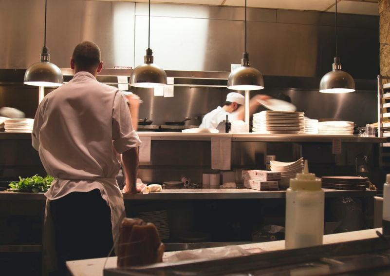 Two chefs in a restaurant kitchen