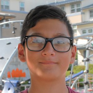 A young smiling boy with glasses