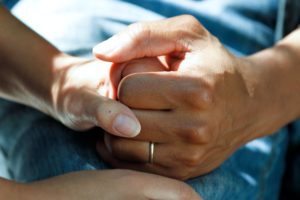 Two hands clasped together