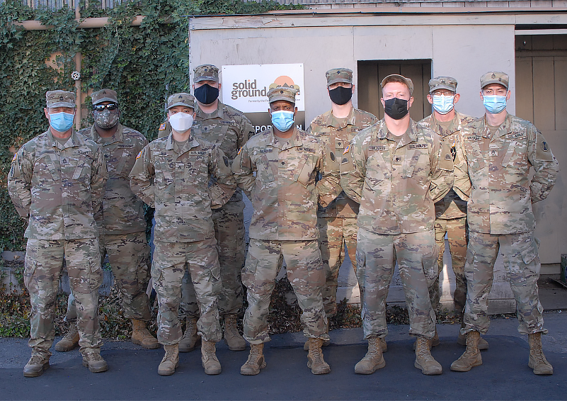 Uniformed National Guard soldiers standing at attention.