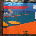A painting of a pontoon plain flying in over the water.