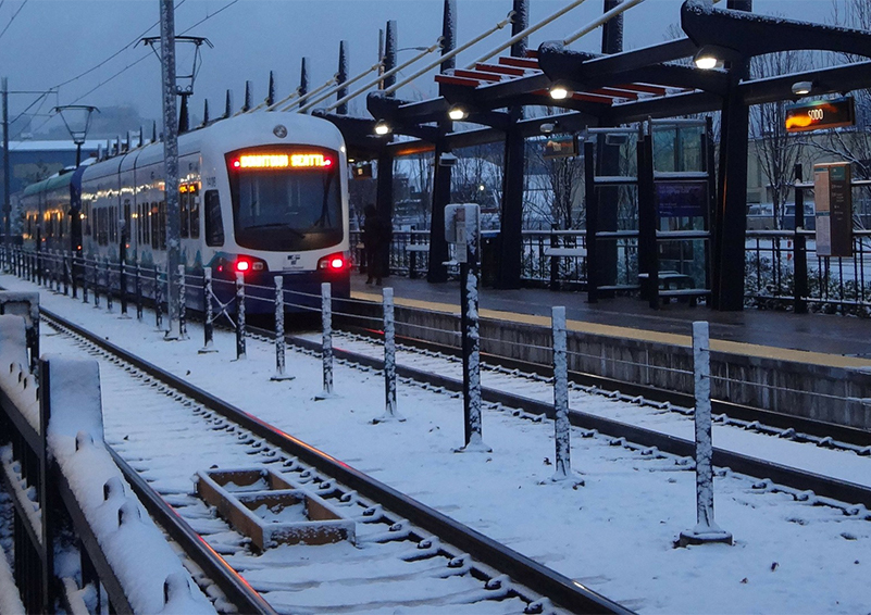A Link train pulls into a snow station in Seattle.