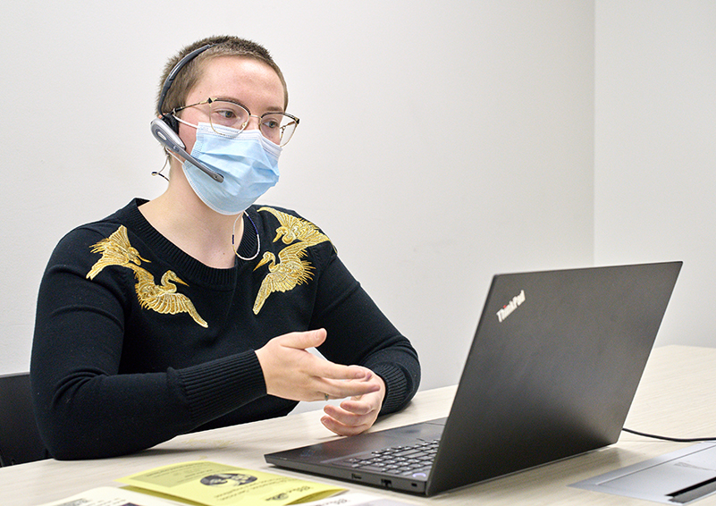 Solid Ground tenant counselor Olivia Mansker-Stoker faces a laptop while leading a tenants' rights webinar.