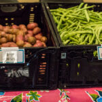 Crates of potatoes and green beans.